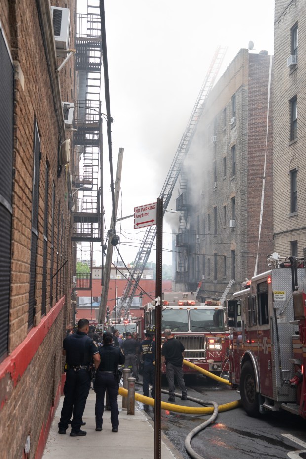 FDNY firefighters work the scene during a massive Bronx fire in a five-story apartment building on E. 209th St. near Parkside Place in the Bronx on Wednesday, Aug. 5, 2026.. (Barry Williams/ New York Daily News)