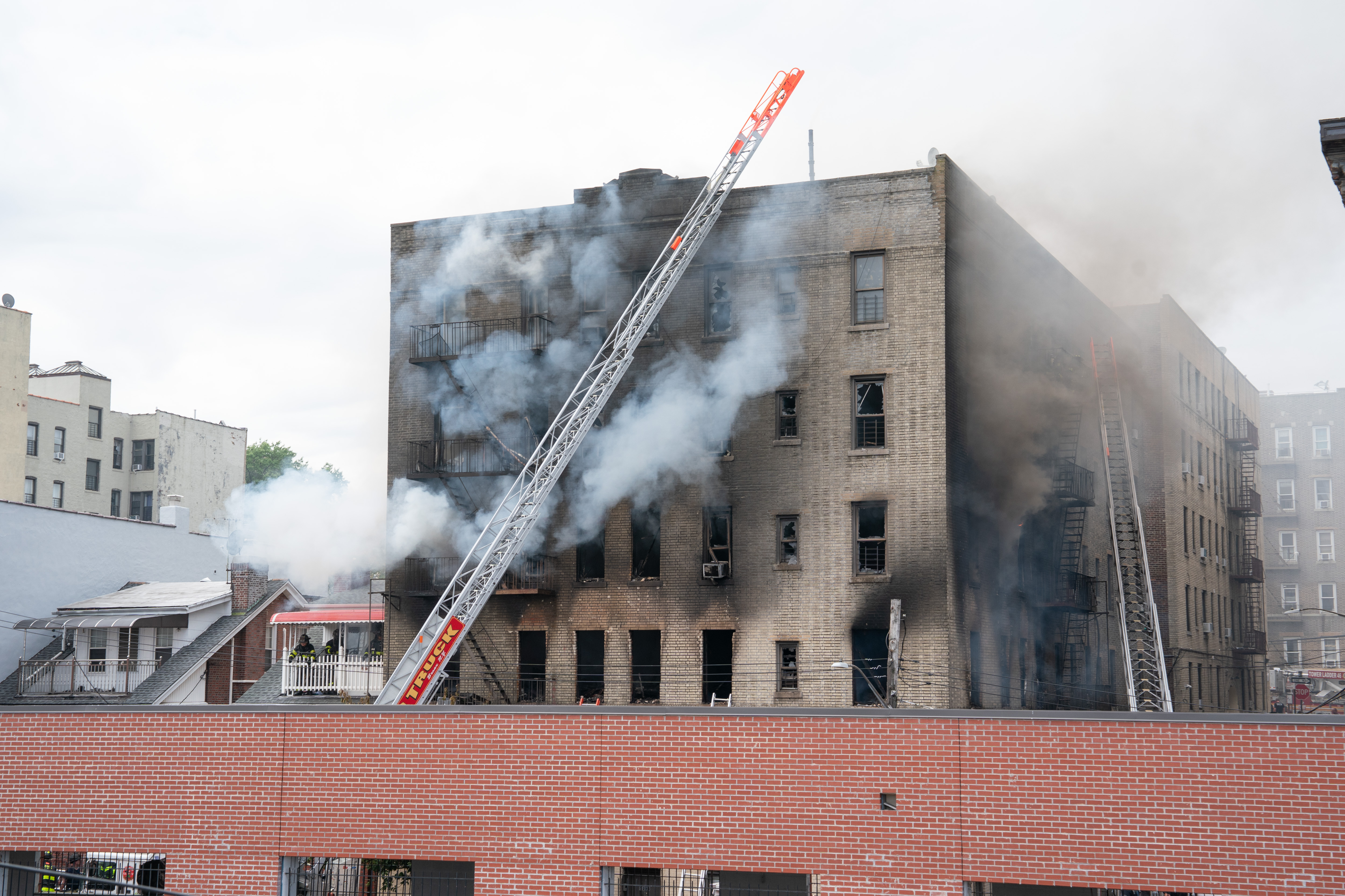 FDNY firefighters work the scene during a massive Bronx fire in a five-story apartment building on E. 209th St. near Parkside Place in the Bronx on Wednesday, Aug. 5, 2026.. (Barry Williams/ New York Daily News)