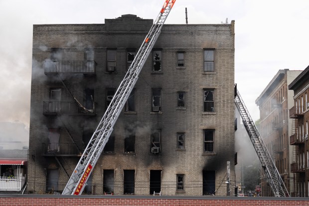 FDNY firefighters work the scene during a massive fire in a five-story apartment building on E. 209th St. near Parkside Place in the Bronx on Wednesday, Aug. 5, 2026.. (Barry Williams/ New York Daily News)