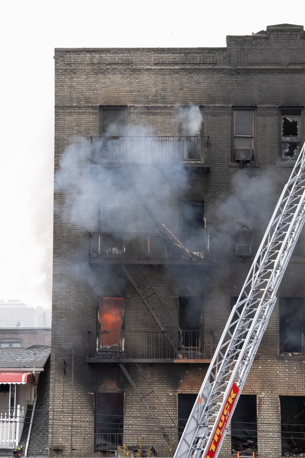 FDNY firefighters work the scene during a massive Bronx fire in a five-story apartment building on E. 209th St. near Parkside Place in the Bronx on Wednesday, Aug. 5, 2026.. (Barry Williams/ New York Daily News)