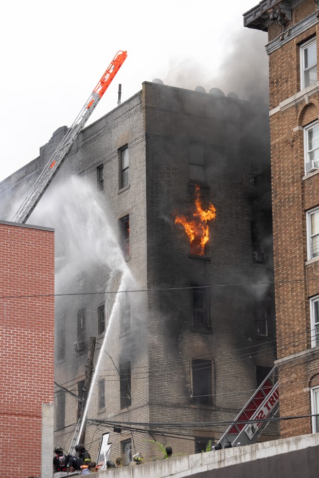 FDNY firefighters work the scene during a massive Bronx fire in a five-story apartment building on E. 209th St. near Parkside Place in the Bronx on Wednesday, Aug. 5, 2026. (Barry Williams/ New York Daily News)