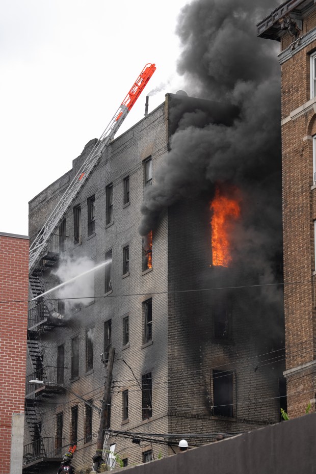 FDNY firefighters work the scene during a massive fire in a five-story apartment building on E. 209th St. near Parkside Place in the Bronx on Wednesday, Aug. 5, 2026. (Barry Williams/ New York Daily News)