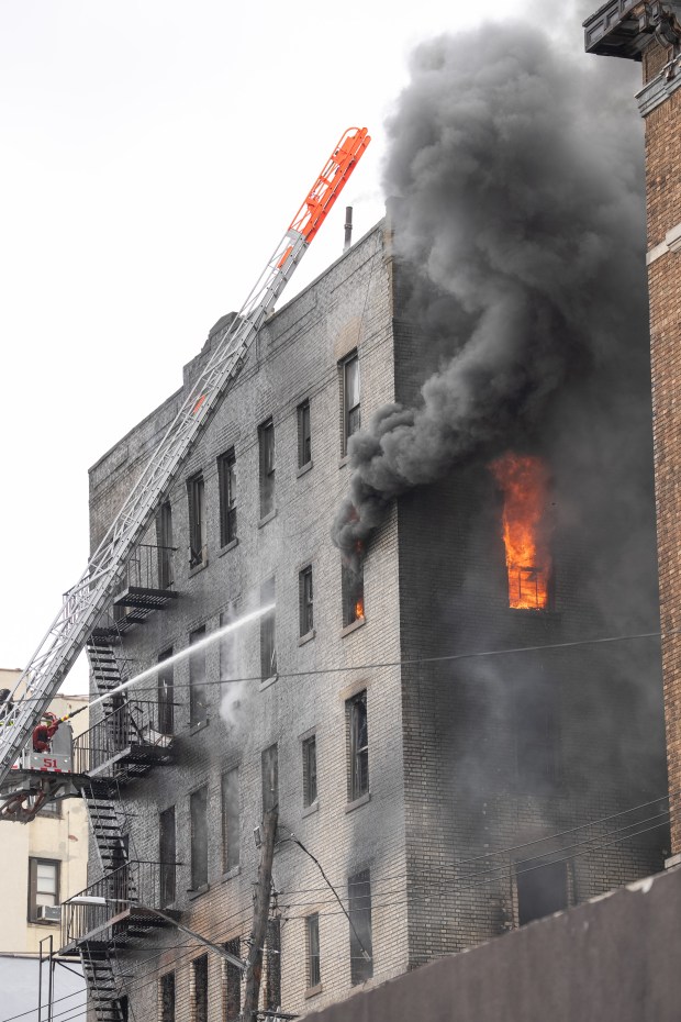 FDNY firefighters work the scene during a massive Bronx fire in a five-story apartment building on E. 209th St. near Parkside Place in the Bronx on Wednesday, Aug. 5, 2026.. (Barry Williams/ New York Daily News)