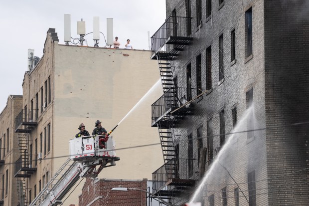 FDNY firefighters work the scene of the massive Bronx fire in a five-story apartment building on E. 209th St. near Parkside Place in the Bronx on Wednesday, Aug. 5, 2026. (Barry Williams/ New York Daily News)