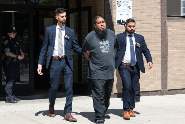 Adrian Benitez, 29, is pictured in police custody leaving the NYPD's 72nd Precinct stationhouse in Brooklyn on Tuesday, Aug. 25, 2026. (Gardiner Anderson / New York Daily News)