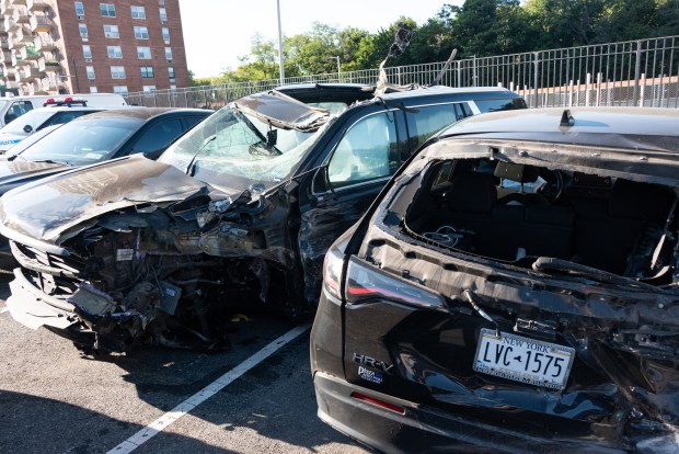 A mangled Cadillac Escalade and Honda HR-V are pictured in a police lot in Brooklyn, New York on Wednesday, Aug. 26, 2026, after three teens were killed in a late-night crash on the Belt Parkway. (Gardiner Anderson / New York Daily News)