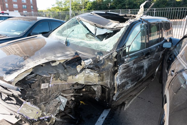 A mangled Cadillac Escalade is pictured in a police lot in Brooklyn, New York on Wednesday, Aug. 26, 2026, after three teens were killed in a late-night crash on the Belt Parkway. (Gardiner Anderson / New York Daily News)