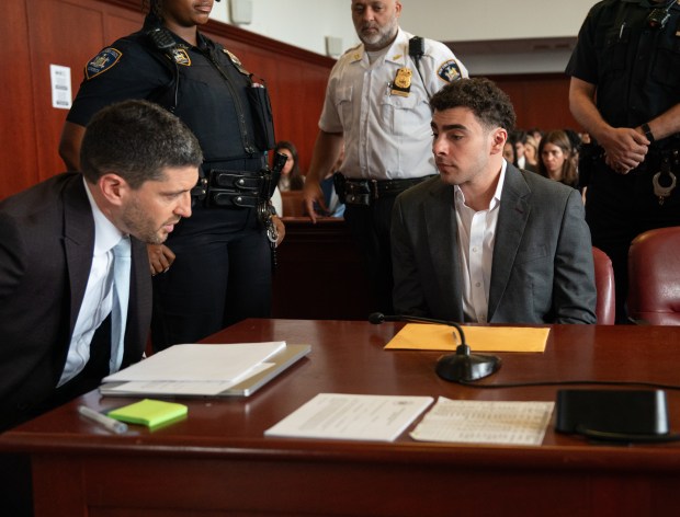 Luigi Mangione, right, speaks with one of his lawyers in Manhattan Supreme Court on Tuesday, Aug. 11, 2026, in Manhattan, New York. (Barry Williams / New York Daily News)
