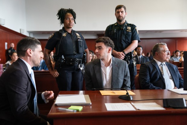 Luigi Mangione, right, speaks with one of his lawyers in Manhattan Supreme Court on Tuesday, Aug. 11, 2026, in Manhattan, New York. (Barry Williams / New York Daily News)