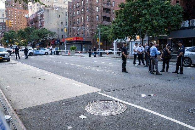Police investigate after a 66-year-old man was fatally struck by a hit-and-run driver while crossing 9th Ave. mid-block near W. 55th St. in Hell's Kitchen, Manhattan, on Saturday, Aug. 8, 2026. (Theodore Parisienne / New York Daily News)
