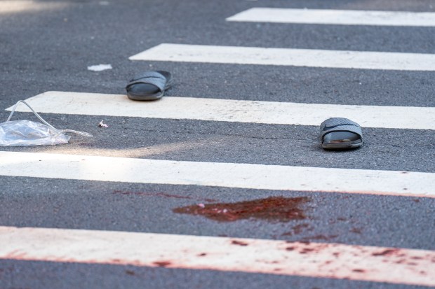 Police investigate after a man who fell unconscious in the street after fighting a rival early Saturday, Aug. 8, 20206, was run over by two passing vehicles, one a marked NYPD police cruiser, on College Ave. near E. 166th St. (Theodore Parisienne / New York Daily News)