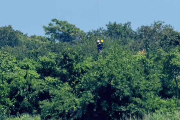 A 64-year-old woman is pictured being airlifted to safety by the NYPD after she got lost in the thick brush between Flatbush Ave. and Dead Horse Bay, near the Marine Parkway Bridge connecting Brooklyn to the Rockaways on Sunday, Aug. 2, 2026. (Theodore Parisienne / New York Daily News)