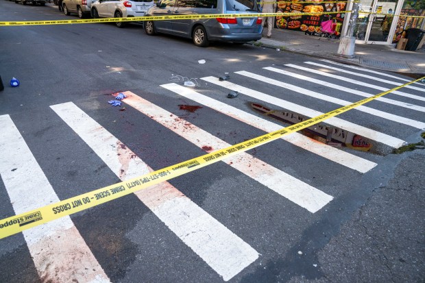 Police investigate after a man who fell unconscious in the street after fighting a rival early Saturday, Aug. 8, 20206, was run over by two passing vehicles, one a marked NYPD police cruiser, on College Ave. near E. 166th St. (Theodore Parisienne / New York Daily News)