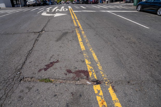 Blood is seen on the road after a 53-year-old man was grievously injured when he was hit by the driver of a Nissan Altima at Boston Road and Corsa Ave. in the Bronx on Friday.