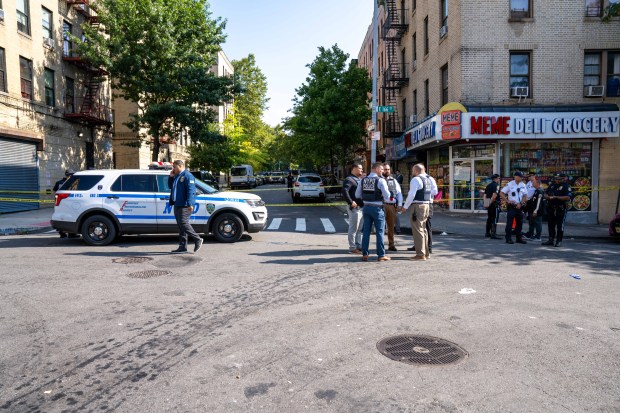 Police investigate after a man who fell unconscious in the street after fighting a rival early Saturday, Aug. 8, 20206, was run over by two passing vehicles, one a marked NYPD police cruiser, on College Ave. near E. 166th St. (Theodore Parisienne / New York Daily News)
