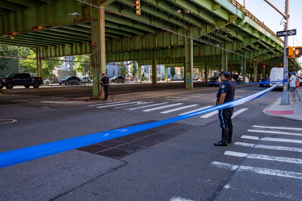 The NYPD Highway Patrol investigates after a woman was fatally struck by a Cadillac Escalade on Third Ave. in Sunset Park on Saturday.