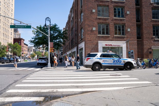 A 22yr old woman walking westbound on West Washington Place and crossing 6th Avenue using the southern crosswalk was pronounced dead at Bellevue Hospital after a grey colored vehicle struck her in Manhattan on Sunday August 23, 2026. 1048. The driver then fled the scene in the car. (Theodore Parisienne / New York Daily News)