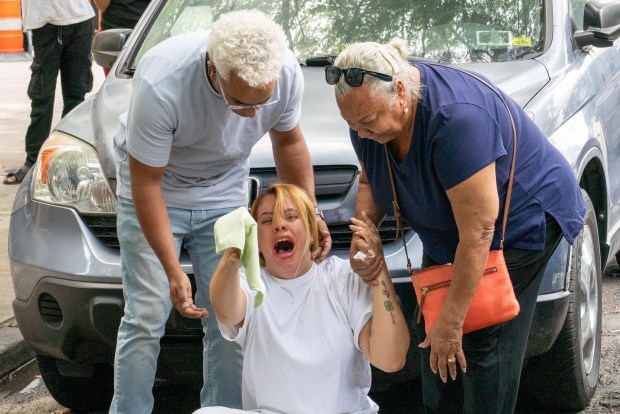 Family members grieve at the scene after a 16-year-old boy was fatally shot inside a house on Prospect Ave. near E.169th St. in the Bronx early Monday.