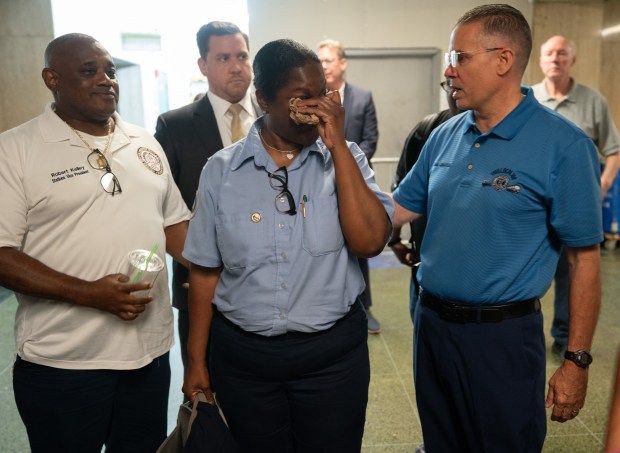 John Chiarello, TWU Local 100 President, comforts MTA station agent Tamika Davis after Robert Ray's sentencing in Manhattan Supreme Court Thursday, Aug. 6, 2026 in Manhattan, New York. Ray seriously assaulted Davis in 2024. (Barry Williams/ New York Daily News)