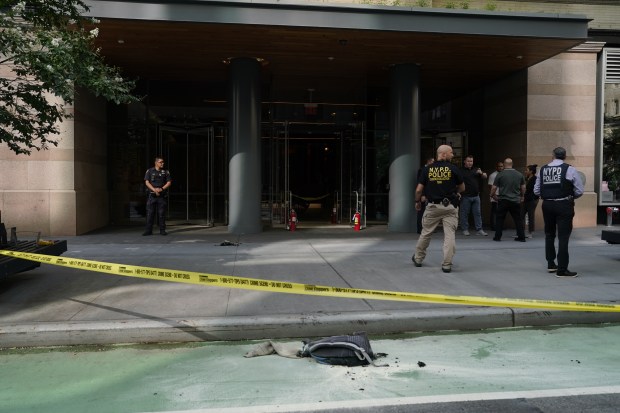 Police investigate after a backpack carried by John Butch, 65, burst into flames at a lower Manhattan office building on Friday.