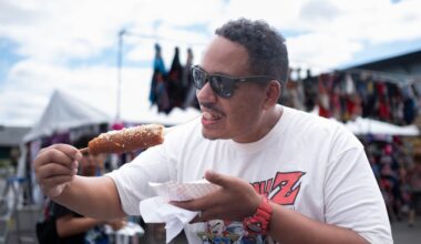 A man at the fair last year eats a Korean corn dog