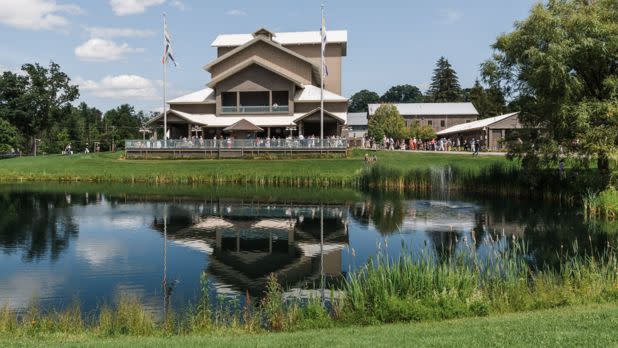 View of Glimmerglass Festival from across a lake on a sunny summer day