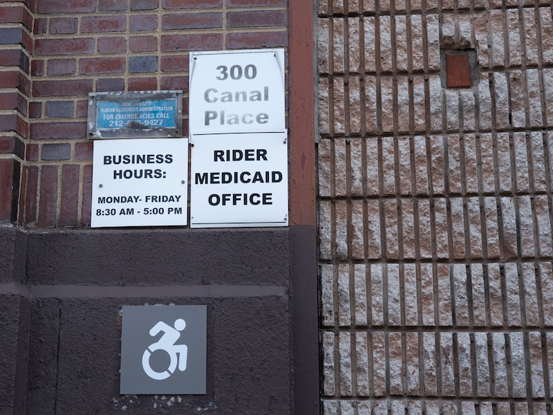 Signs outside of a red brick building