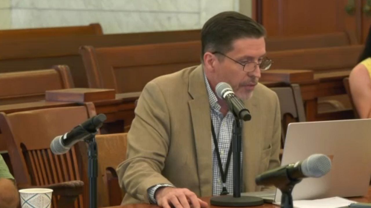 man speaking in a microphone