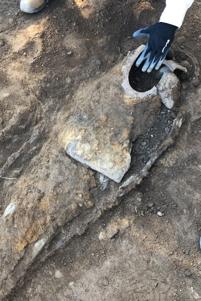 Members of a church helped unearth iron coffins at an African burial ground beneath an Elmhurst, Queens parking lot.
