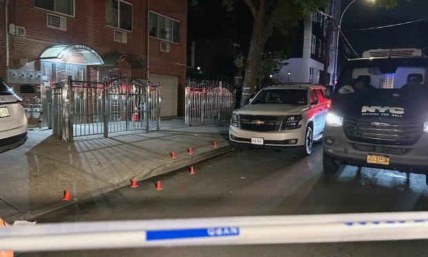 Shell casings are marked on the sidewalk after Klint French, 39, was fatally shot on Grand Ave. near W. 190th St. in the Bronx on Tuesday night.