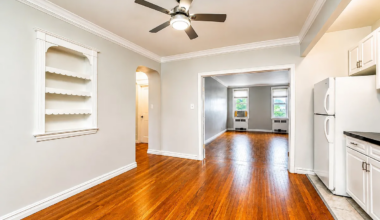 entry with kitchen in an alcove, french doors open to show living room