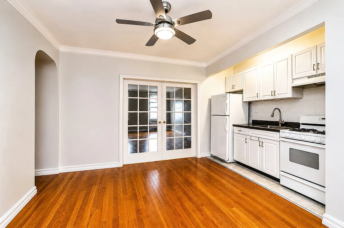 entry with kitchen in a nook and french doors to living room