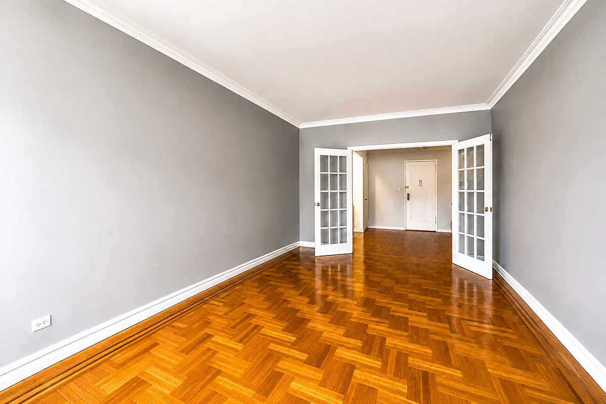 living room with french doors to foyer, wood floor