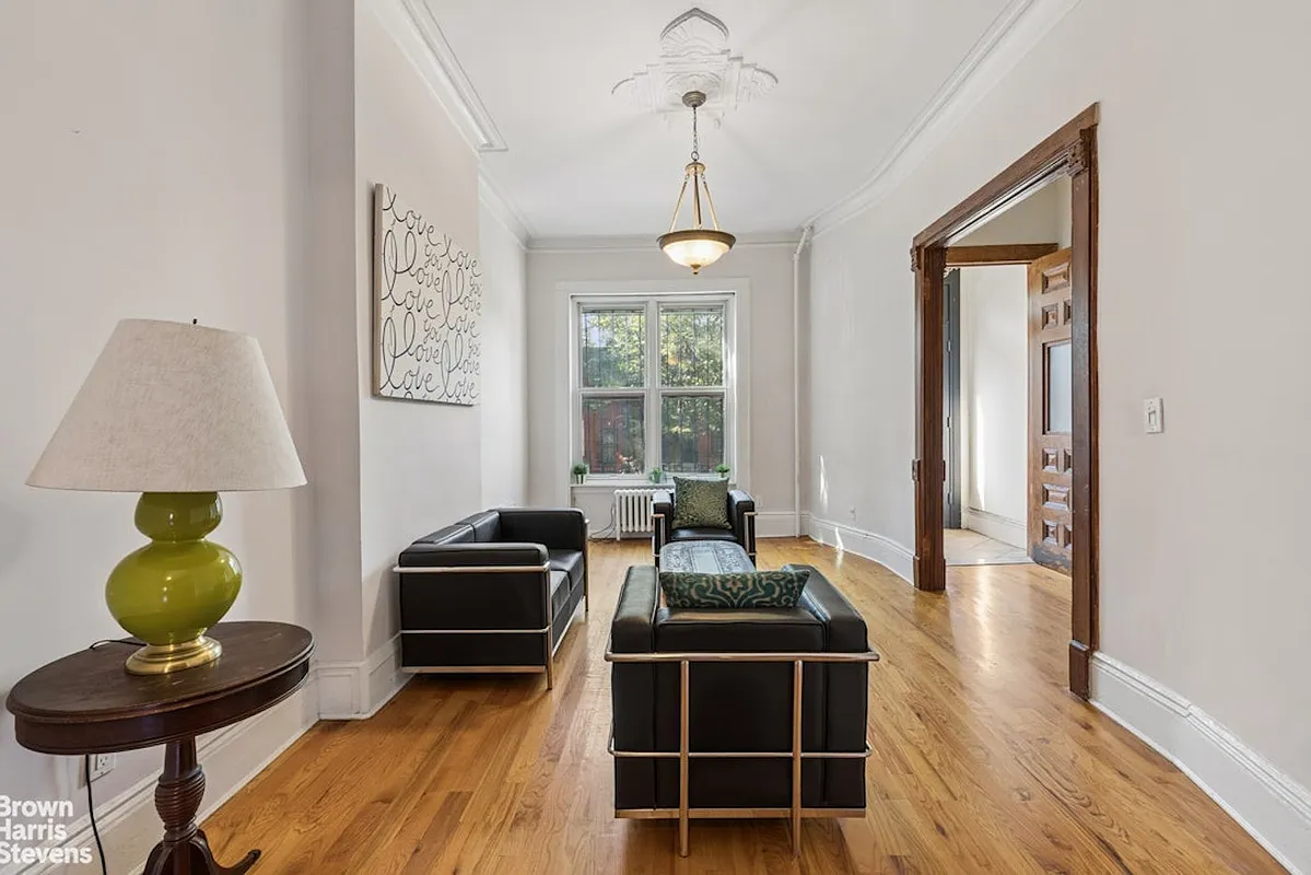parlor with wood floor, ceiling medallion