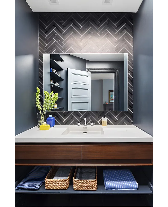 bathroom with black wall tile, long vanity