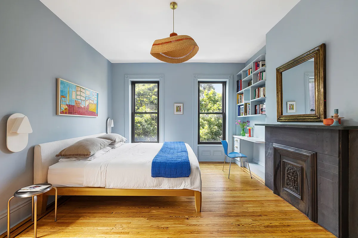bedroom with blue walls, stone mantel