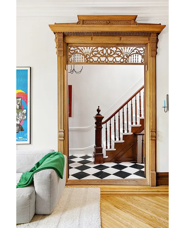 view into front entry hall with checkerboard floor and original stair
