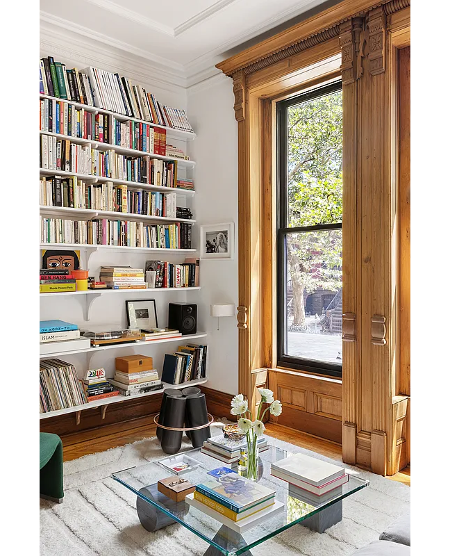 parlor with wall of shelves, original window moldings