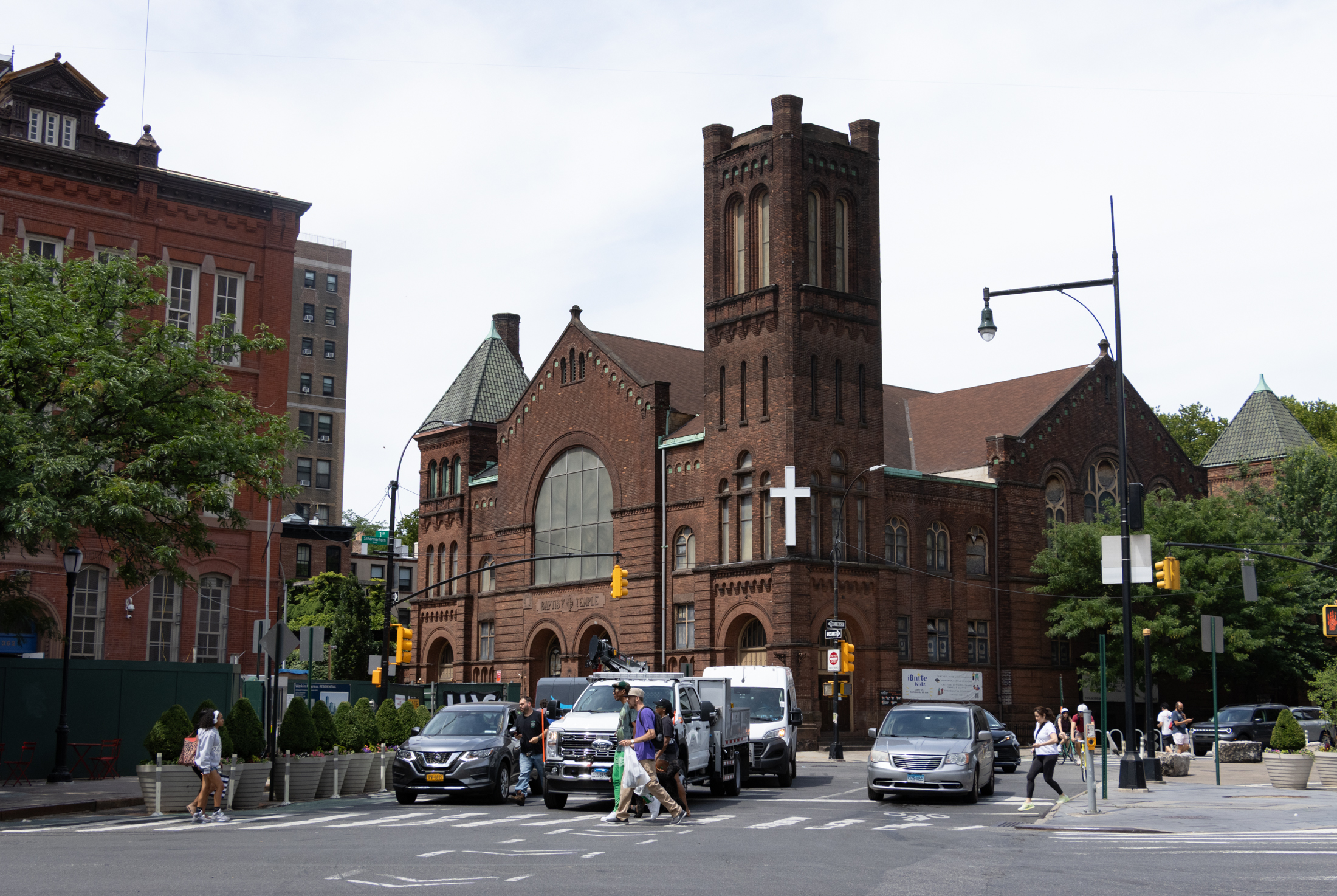 church with tower and a white cross