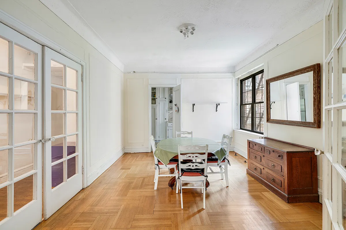 dining room with French doors, wall moldings, wood floor