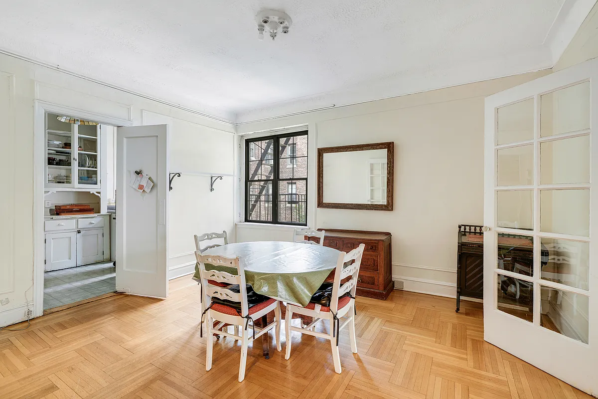 brooklyn heights - dining room with wall moldings, wood floor, view into kitchen