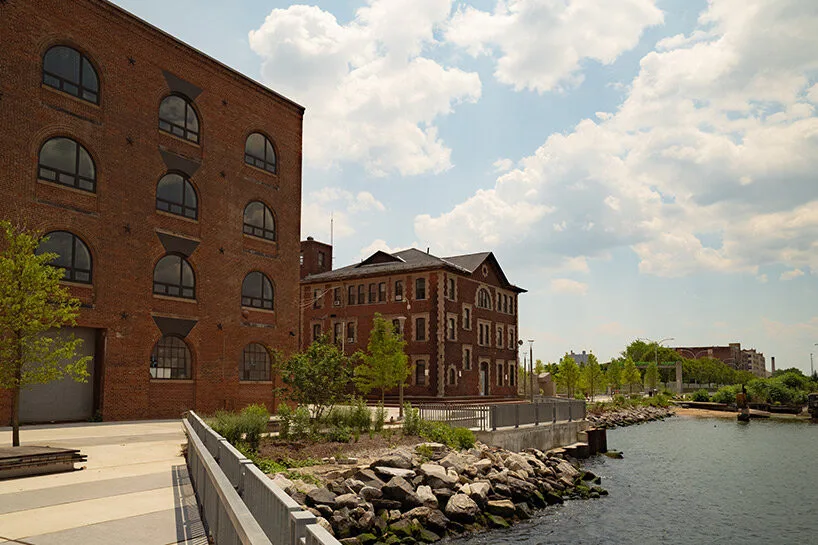 View of historic red brick buildings under a clear blue sky.