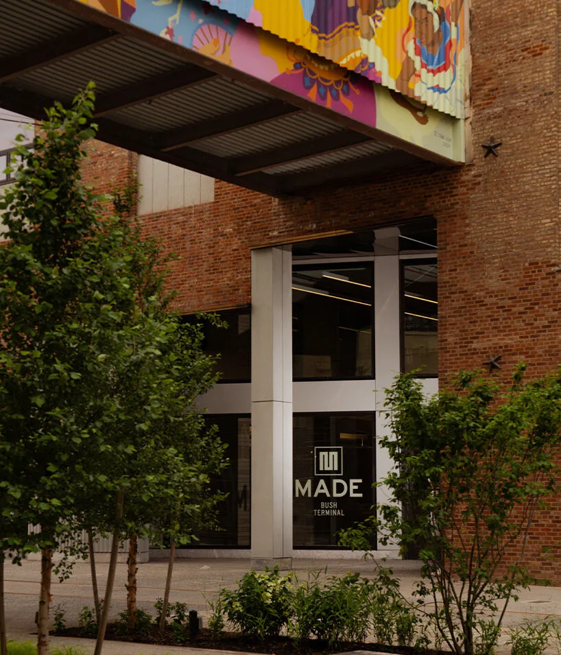 Colorful murals adorn industrial warehouse, reflecting local artistic scene.