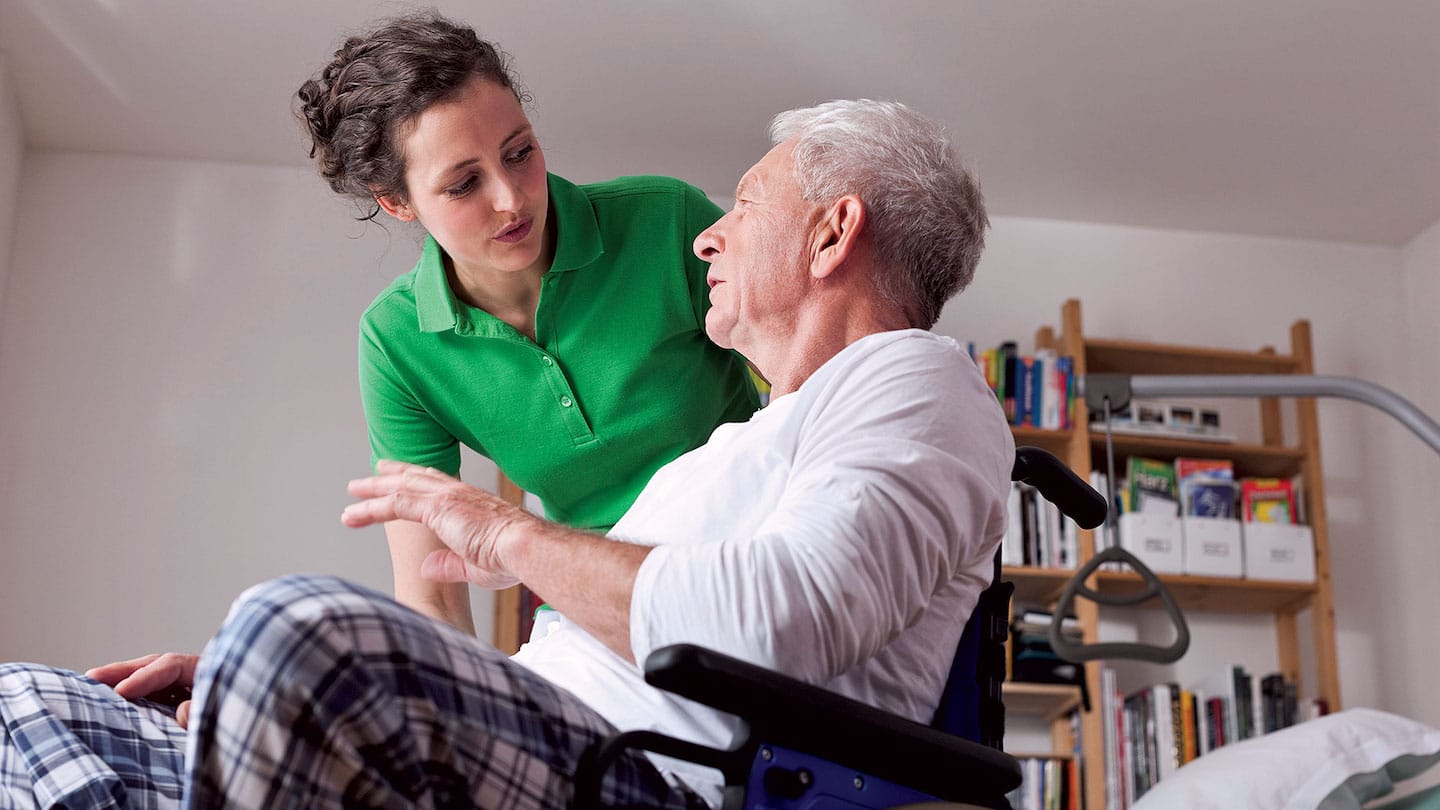 Aide helping resident