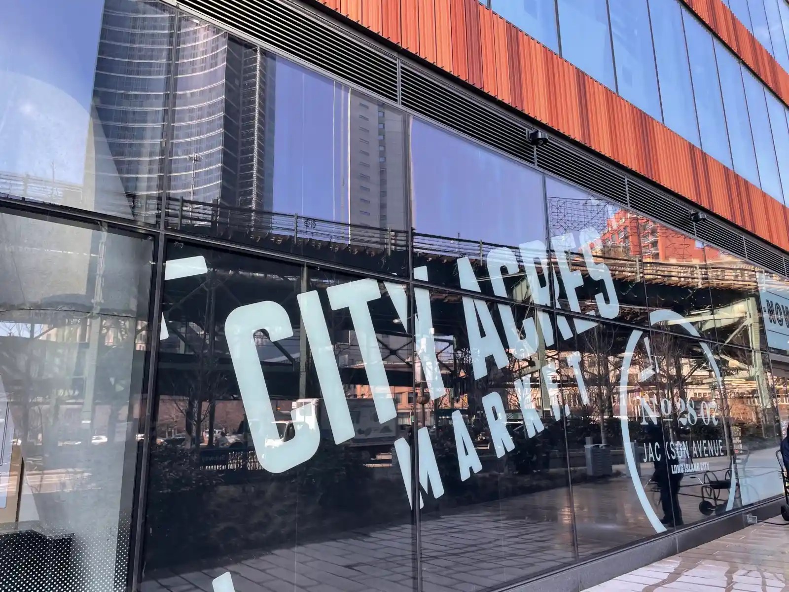 The victim was walking past the City Acres Market on the ground floor of The Jacx on Queens Plaza South. 