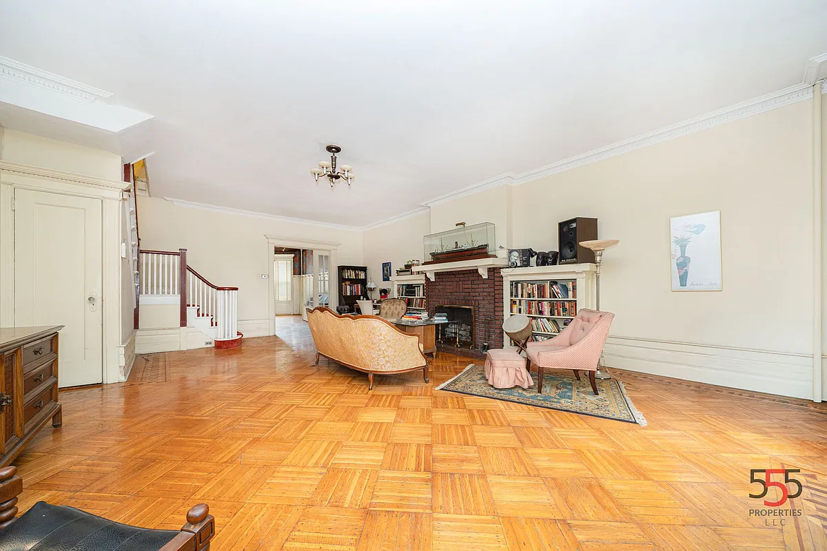a parlor with a brick mantel