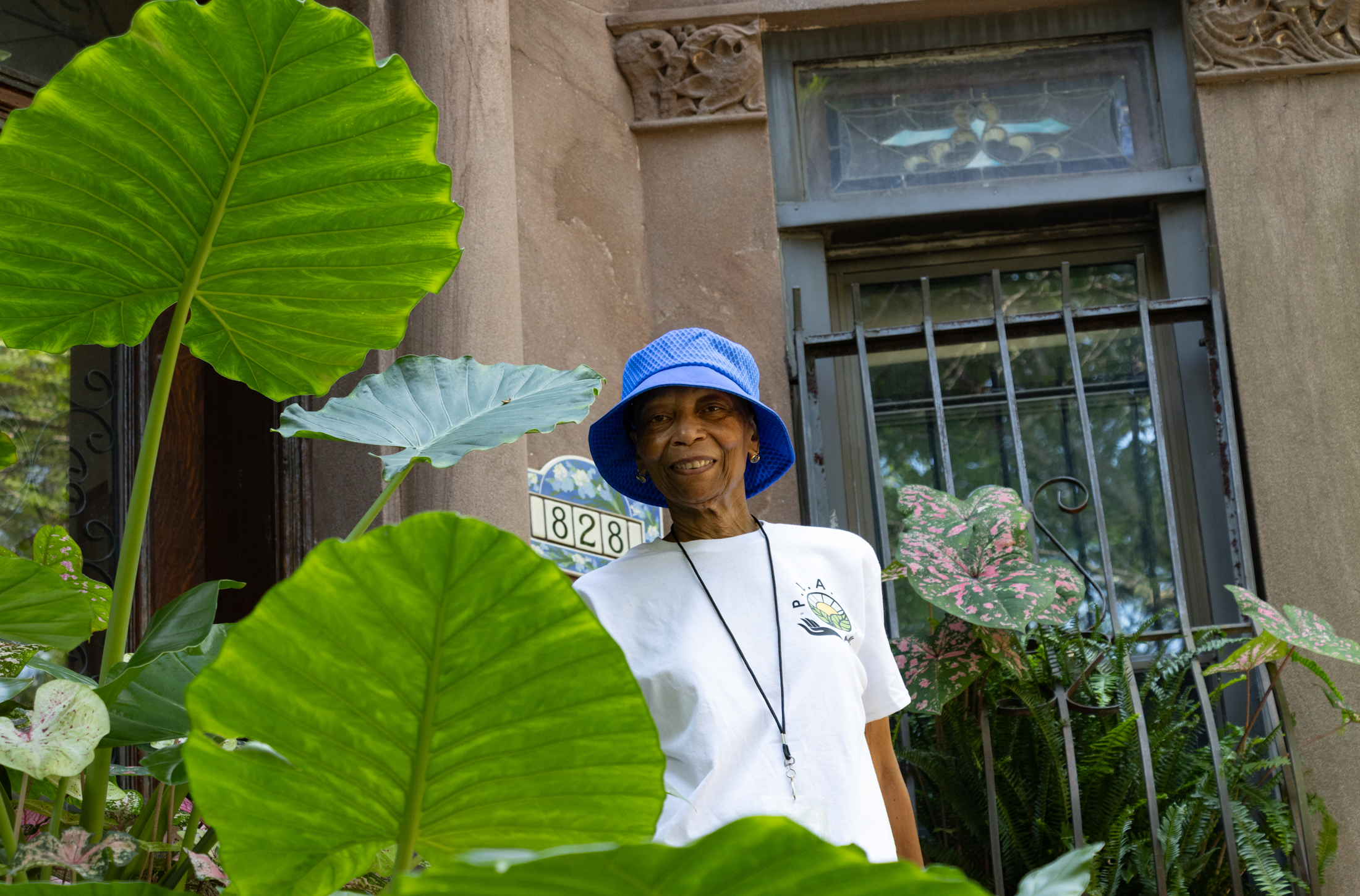 woman on a stoop surrounded by plants