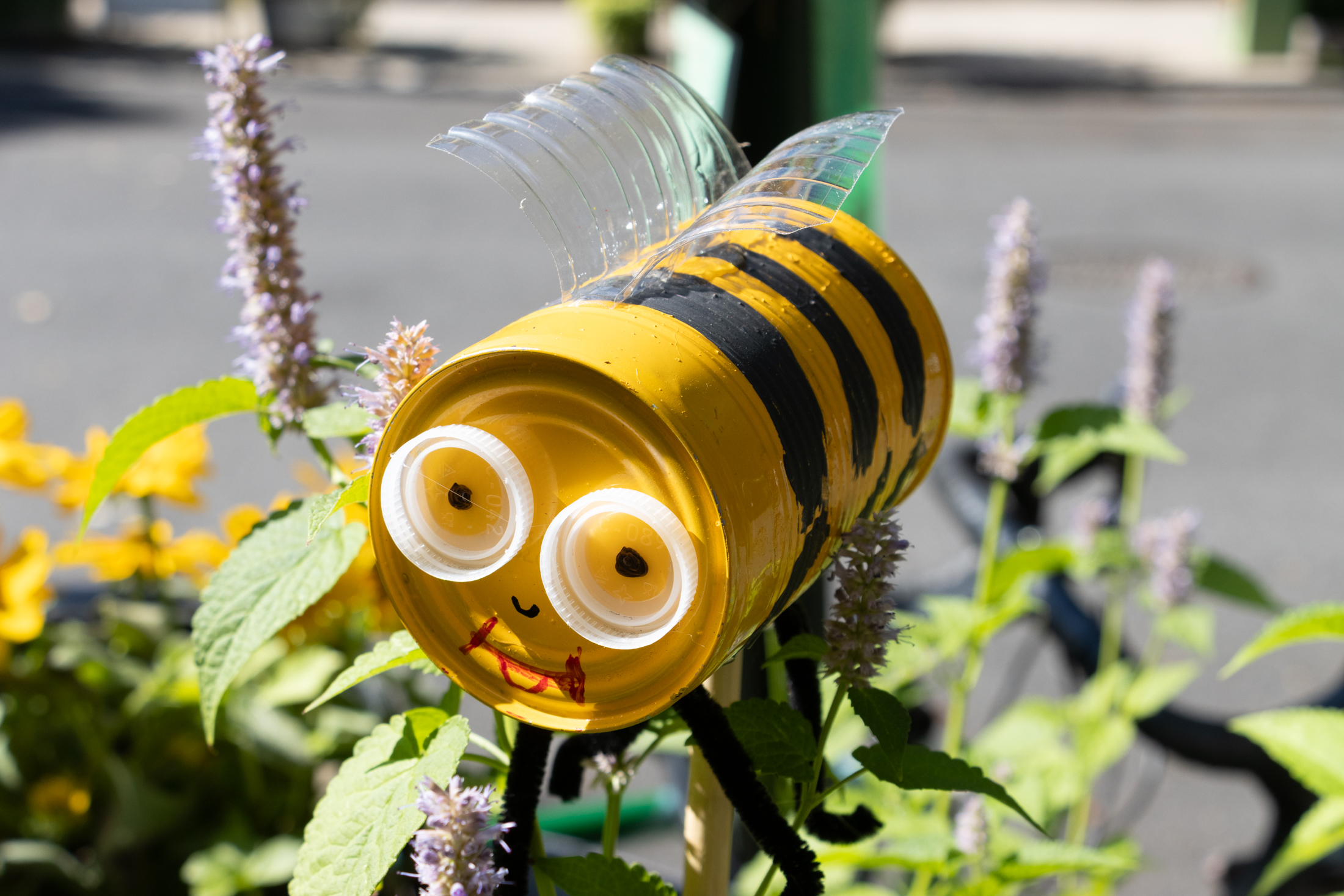 a tin can painted like a bee