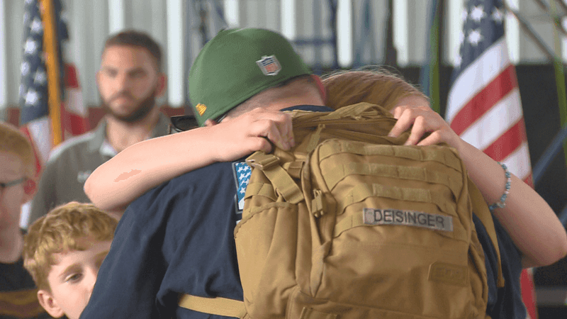 One of 72 veterans who returned from 'Missions of Honor: Freedom to Liberty' hugs his family, Aug. 30, 2026. (WLUK/Don Steffen)