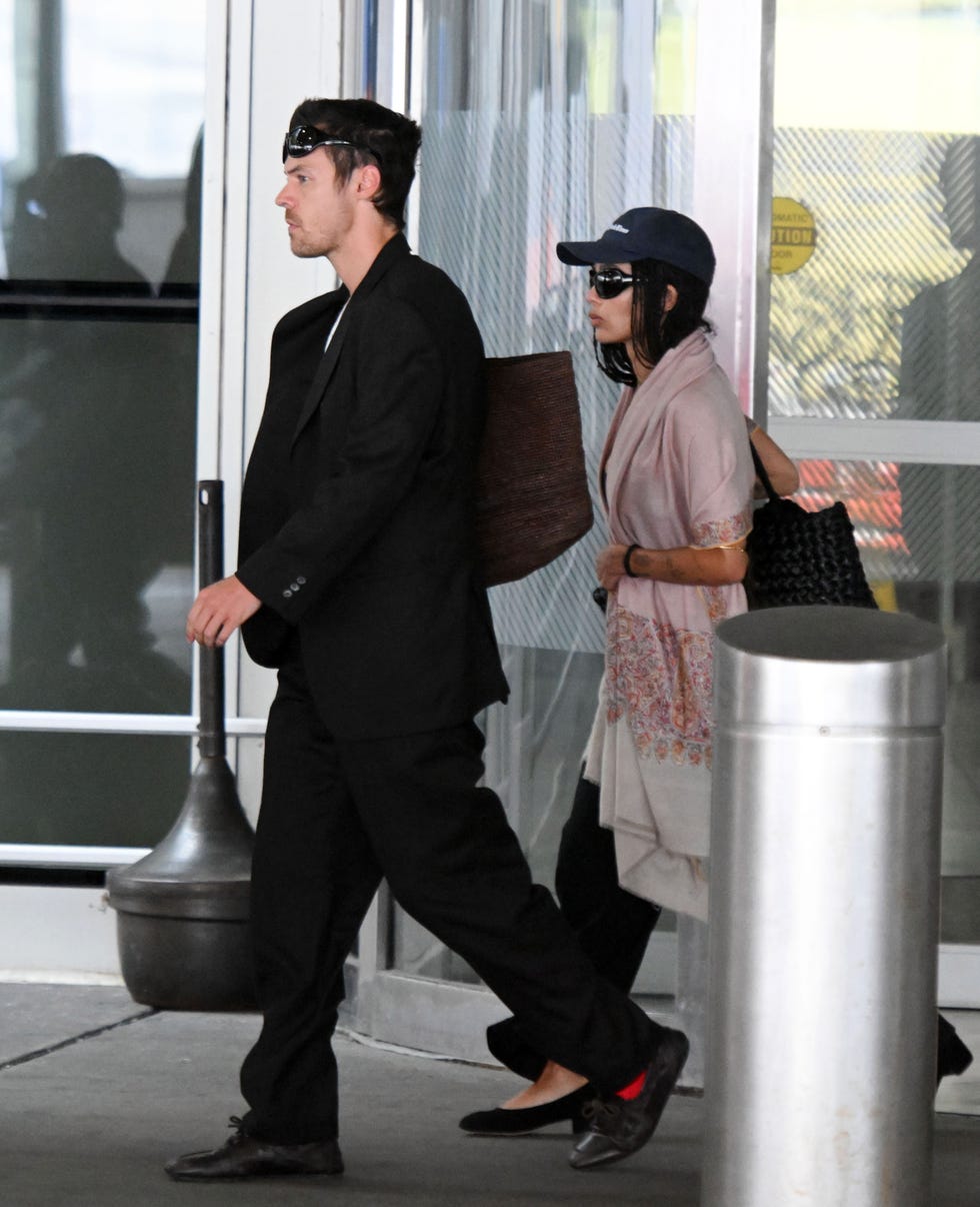 08212026 exclusive harry styles and zoe kravitz are spotted arriving to jfk airport in new york city the freshly engaged couple were spotted ahead of harry's 30 show run at madison square garden zoe flashed her diamond ring while wearing a baseball cap, pink scarf, crop top, black trousers, and matching heelsvideo availablesalestheimagedirectcom please bylinetheimagedirectcomexclusive please email salestheimagedirectcom for fees before use